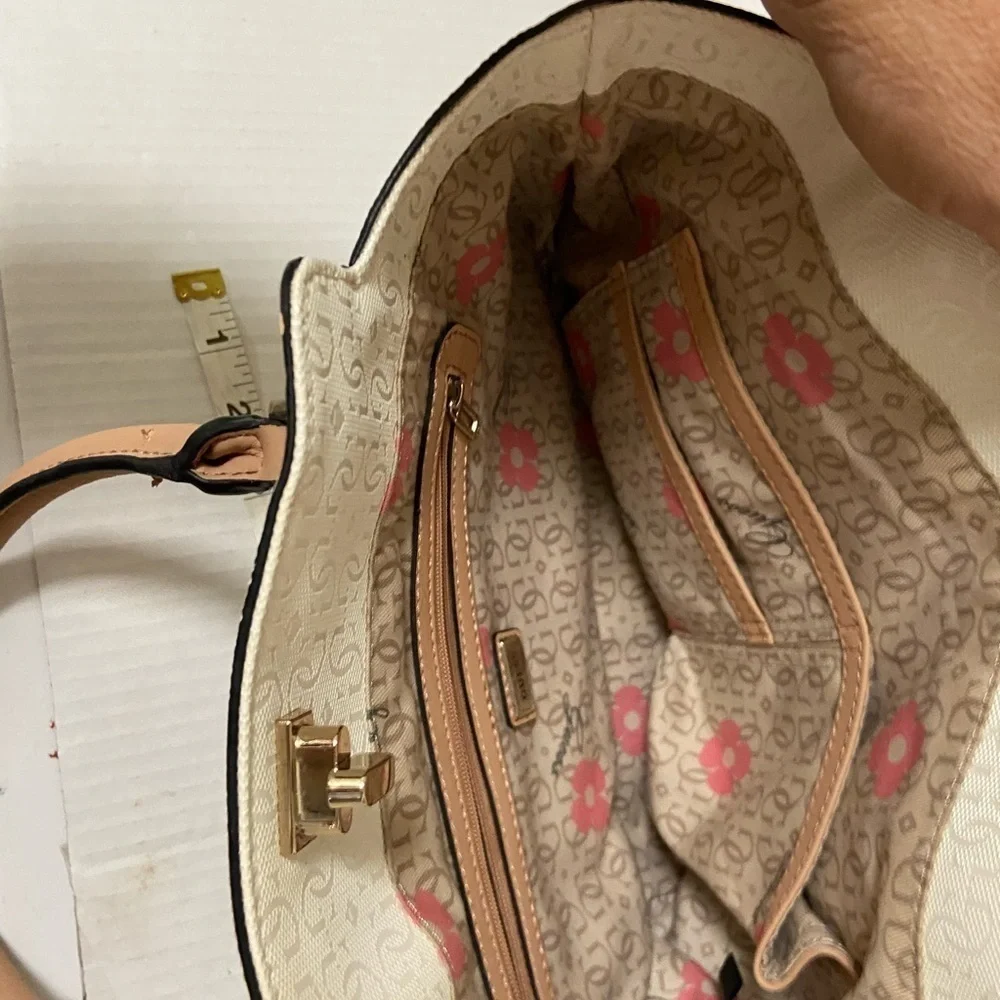 Guess purse cream w black flowers useful but well loved $49